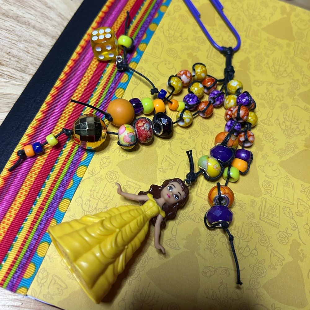 Vibrant Beaded Belle Book Charm on a Large paper clip.